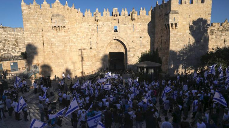 Jewish ultranationalists wave Israeli flags participate in the Flags March next to Damascus gate, outside East Jerusalem's Old City, Tuesday, June 15, 2021. AP.jpg