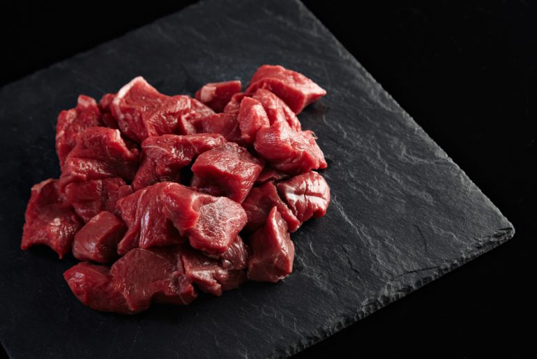 pieces-raw-fresh-meat-isolated-black-stone-board-side